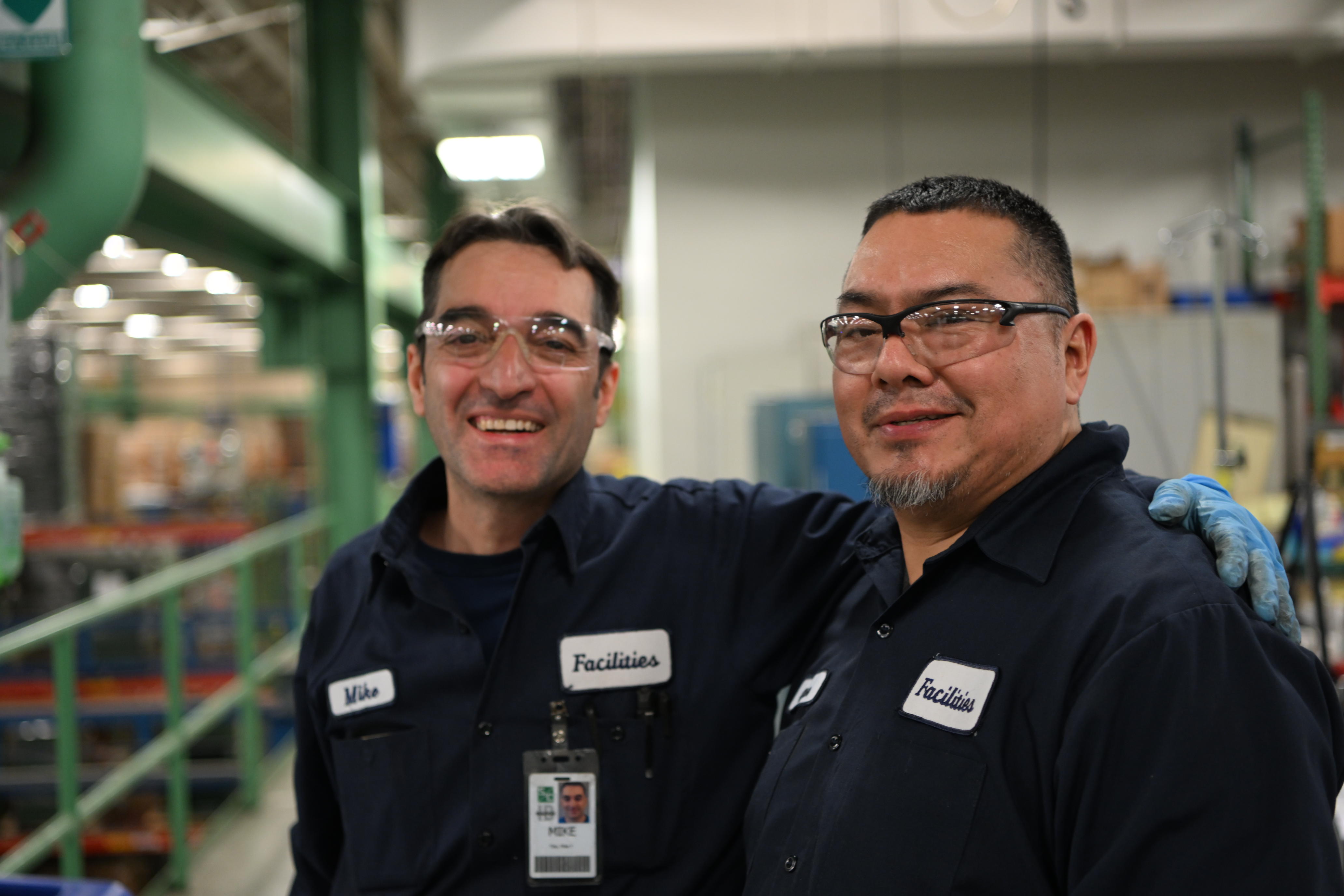 Operational Excellence at S&C Two team members smile for the camera in S&C's manufacturing facility in Chicago, IL.